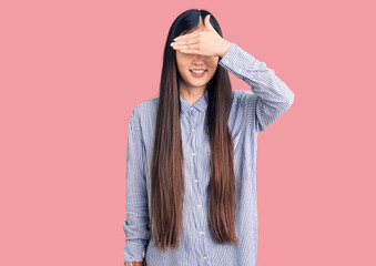 Poster - Young beautiful chinese woman wearing casual shirt smiling and laughing with hand on face covering eyes for surprise. blind concept.