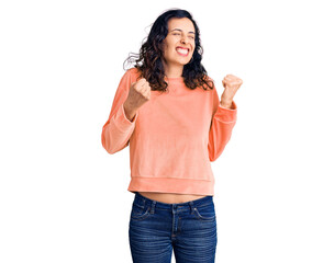 Wall Mural - Young beautiful hispanic woman wearing casual clothes excited for success with arms raised and eyes closed celebrating victory smiling. winner concept.