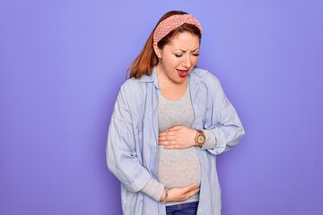 Poster - Young beautiful redhead pregnant woman expecting baby over isolated purple background with hand on stomach because nausea, painful disease feeling unwell. Ache concept.