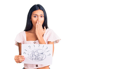 Sticker - Young beautiful latin girl holding scribble draw covering mouth with hand, shocked and afraid for mistake. surprised expression