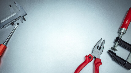 Poster - working tools on metal background. including pliers, screwdriver, clamps, vernier caliper