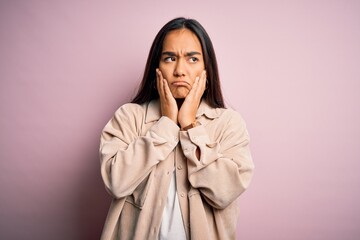 Wall Mural - Young beautiful asian woman wearing casual shirt standing over pink background Tired hands covering face, depression and sadness, upset and irritated for problem