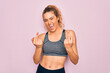 © Krakenimages.com - Young beautiful blonde sportswoman with blue eyes doing exercise wearing sportswear Showing middle finger doing fuck you bad expression, provocation and rude attitude. Screaming excited