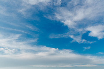 Wall Mural - landscape of stretched clouds of white light against a blue sky