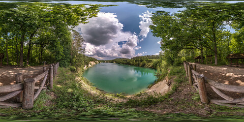 Wall Mural - full seamless spherical hdri panorama 360 degrees angle view on limestone coast of huge green lake or river near forest in summer day with beautiful clouds in equirectangular projection, VR content
