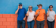 © luciano - Cheerful group of four elderly people using smart phone standing against a colored wall - concept of active tech and social with retired people