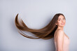 © deagreez - Profile photo of attractive model lady look demonstrate ideal neat long healthy hairstyle flying on air after lamination procedure wear beige singlet isolated grey color background