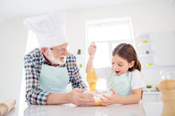 Sticker - Close-up portrait of nice cheerful cheery glad grey-haired grandpa grandchild cooking domestic homemade tasty yummy dough cookies having fun leisure in modern light white interior kitchen house