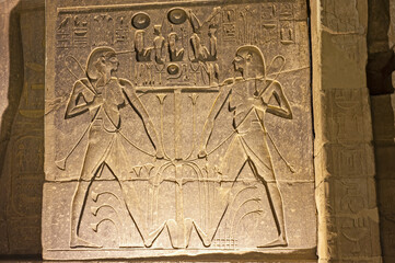 Hieroglyphic carvings on wall at Luxor Temple during night