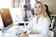 © Iryna - Blond business woman using computer at workplace in sunny office. Working for pleasure and success