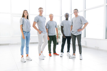 Wall Mural - group of young people standing in an empty office.