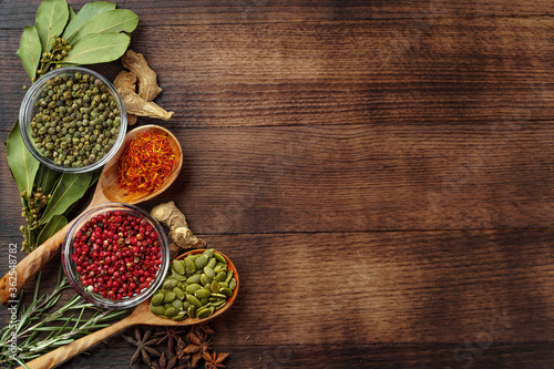 Fotografía Vivid colorful spices in wooden spoons on wooden background
