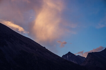Wall Mural - amazing vivid landscape of sunset with silhouettes of rocky mountains and glow orange clouds. atmosp