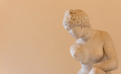 Sticker - Detail of ancient roman marble sculpture in ruins, showing a naked young girl posing