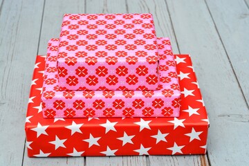 Poster - Closeup shot of three gift boxes stacked on top of each other on a wooden surface