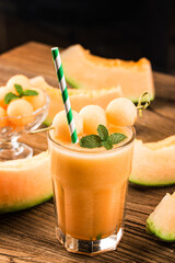 Poster - The juice of melon with mint in a glass on the table.Hami melon