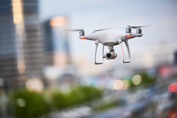 Wall Mural - drone with digital camera flying at city street