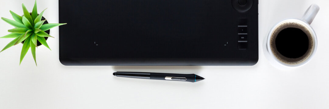 Graphic tablet on a white empty background. Copy space. Computer graphics desk. Panorama