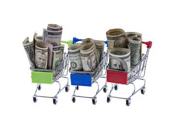 Close up macro view of three shopping carts filled with rolled dollar bills. 