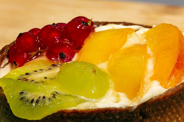 Handmade cake with fruits and berries. Kiwi, red berry, grape, peach. 