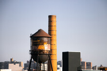 A Rooftop Water Tower Shines Brightly In Brooklyn Afternoon Sun