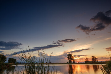 Sticker - Sunset over calm lake , sky reflection in water