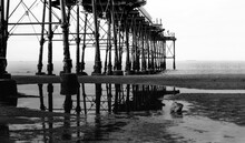 Black And White Photo Of Under Saltburn Pier Down By The Sea In Uk, High Contrast In Balck And White Image Of Photo An Abstract Construction From Under The Bridge.