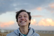 Leinwandbild Motiv Smiling Teenage Boy Looking Away At Beach