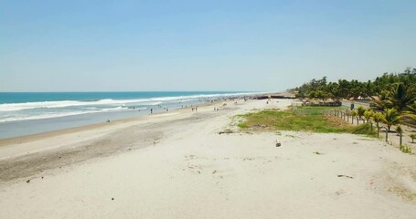 Wall Mural - A large group of beachgoers enjoy the beach during the daytime in El Salvador.