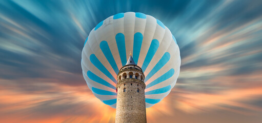 Wall Mural - Hot air balloon flying over Galata tower at amazing sunset - Istanbul, Turkey