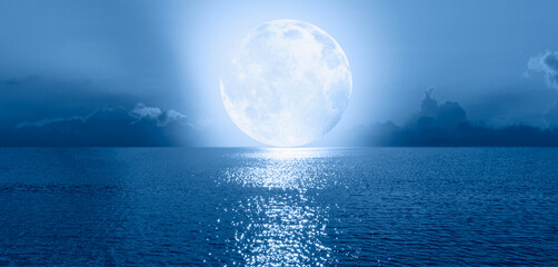 Aufkleber - Night sky with Blue moon in the clouds on the fore ground calm blue sea 