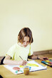 © ImageHit - Girl water painting in the classroom