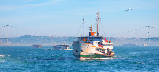 Wall Mural - Sea voyage with old ferry (steamboat) on the Bosporus with Bosphorus bridge - Istanbul, Turkey  