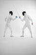 © ImageHit - Two men in fencing suits in a duel