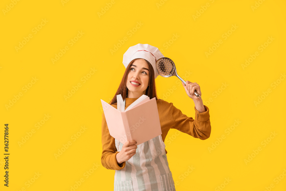 Young woman with recipe book on color background