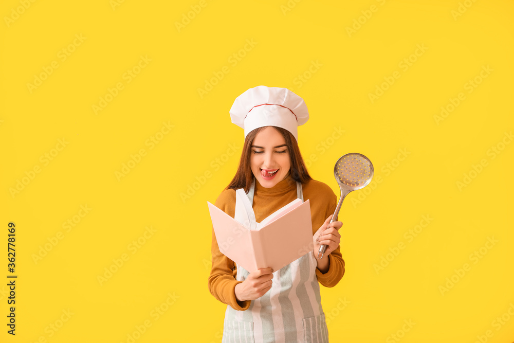 Young woman with recipe book on color background