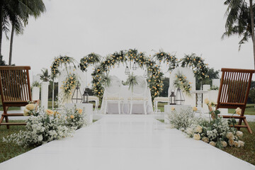 elegant White wedding stage decoration with floral arch gate. outdoor nature wedding concept