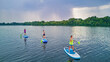 © Iuliia Sokolovska - Active family on SUPs, standing up paddleboards, in river water, summer family sport, aerial top view from above