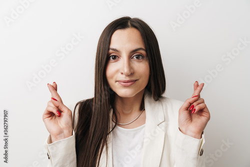 Photo of young businesswoman posing with fingers crossed for good luck Poster Mural XXL
