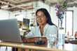 © puhhha - Work. Business Woman In Cafe Portrait. Smiling Freelancer Looking At Screen And Typing. Fashion Girl In Glasses Working On Laptop And Waiting For Lunch In Restaurant.