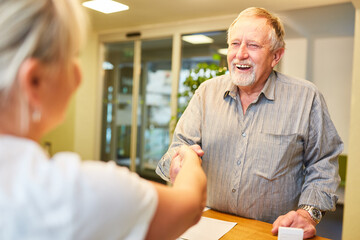 Patient on greeting at reception at the doctor