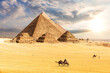The Pyramids in the desert of Giza, Egypt, sun and clouds scenery