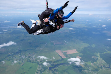 Skydiving. Tandem jump. Two guys are flying in the sky.