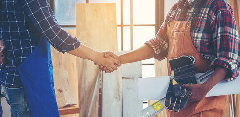 Two carpenters holding hands, The concept of working together until success