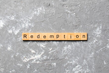 Redemption Word Written On Wood Block. Redemption Text On Cement Table For Your Desing, Concept