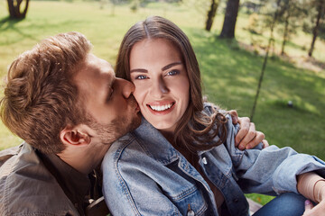 Wall Mural - Happy beautiful woman next to her boyfriend outdoors