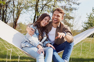 Wall Mural - Happy man is hugging his girlfriend outdoors