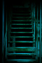 Mystical Horror Staircase To A Dark Basement, Attic In An Old Decrepit Scary Abandoned House With Paranormal Blue Green Light And Terrible Frightening Shadows Causing Fear