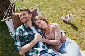 Wall Mural - Happy young man hugging her girlfriend outdoors