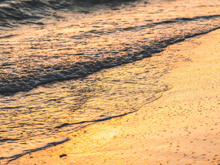 Wall Mural - Close up abstract of ocean waves  coming in to shore at sunrise